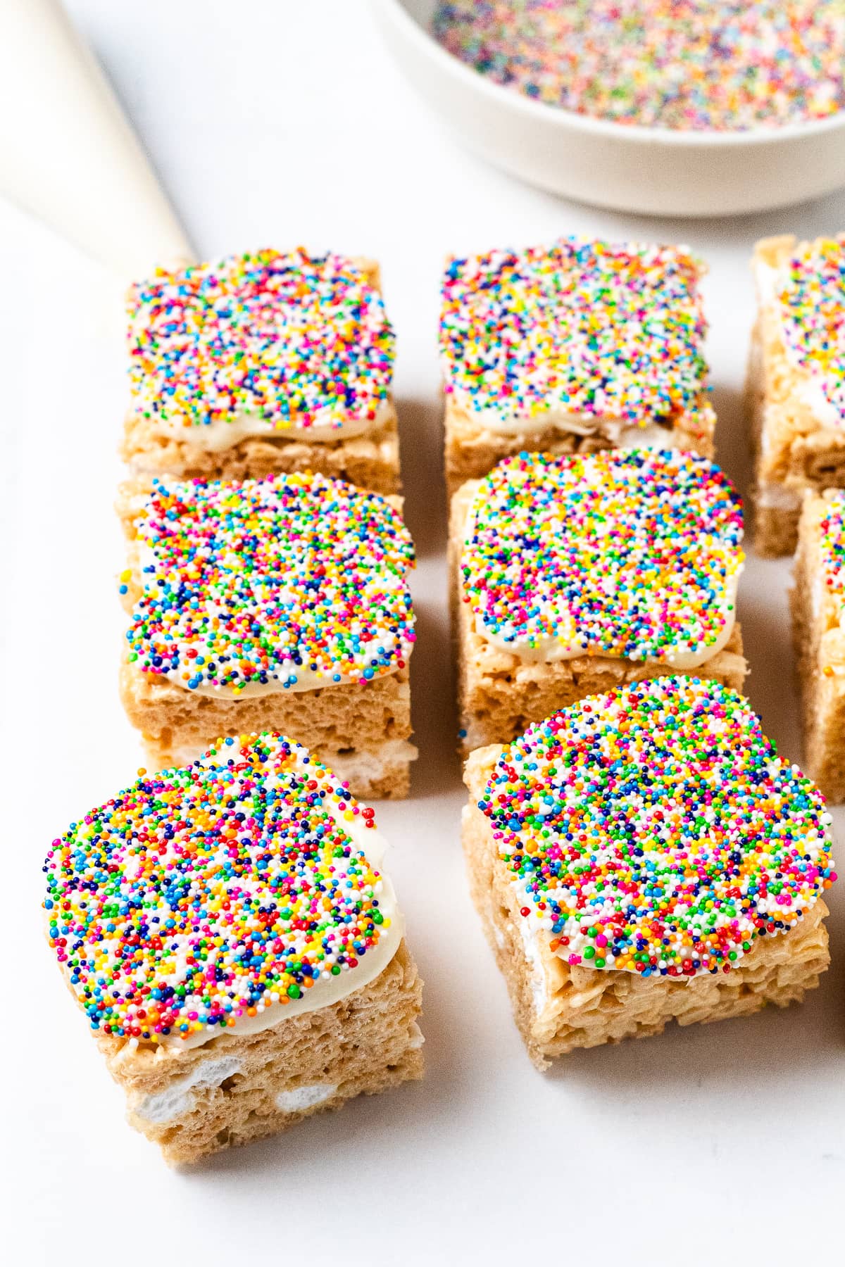 Dot Cake Rice Krispie Treats topped with rainbow dot sprinkles.
