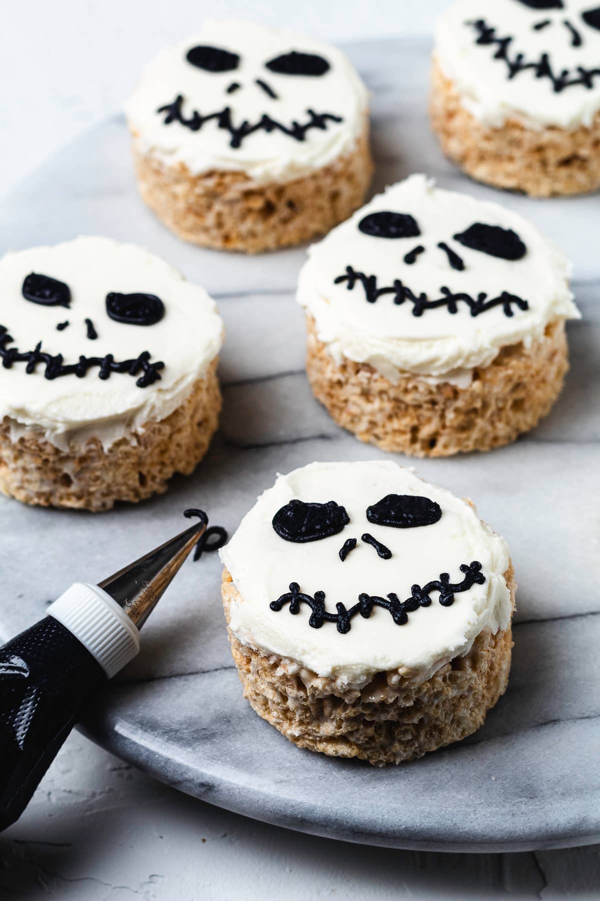Jack Skellington Rice Krispie treats with white frosting and black faces.