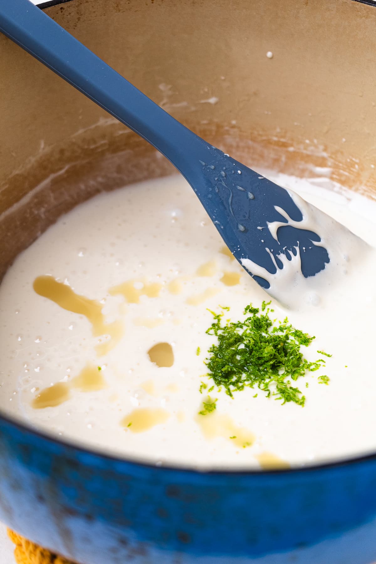 Adding lime zest and key lime juice to melted marshmallow mixture.