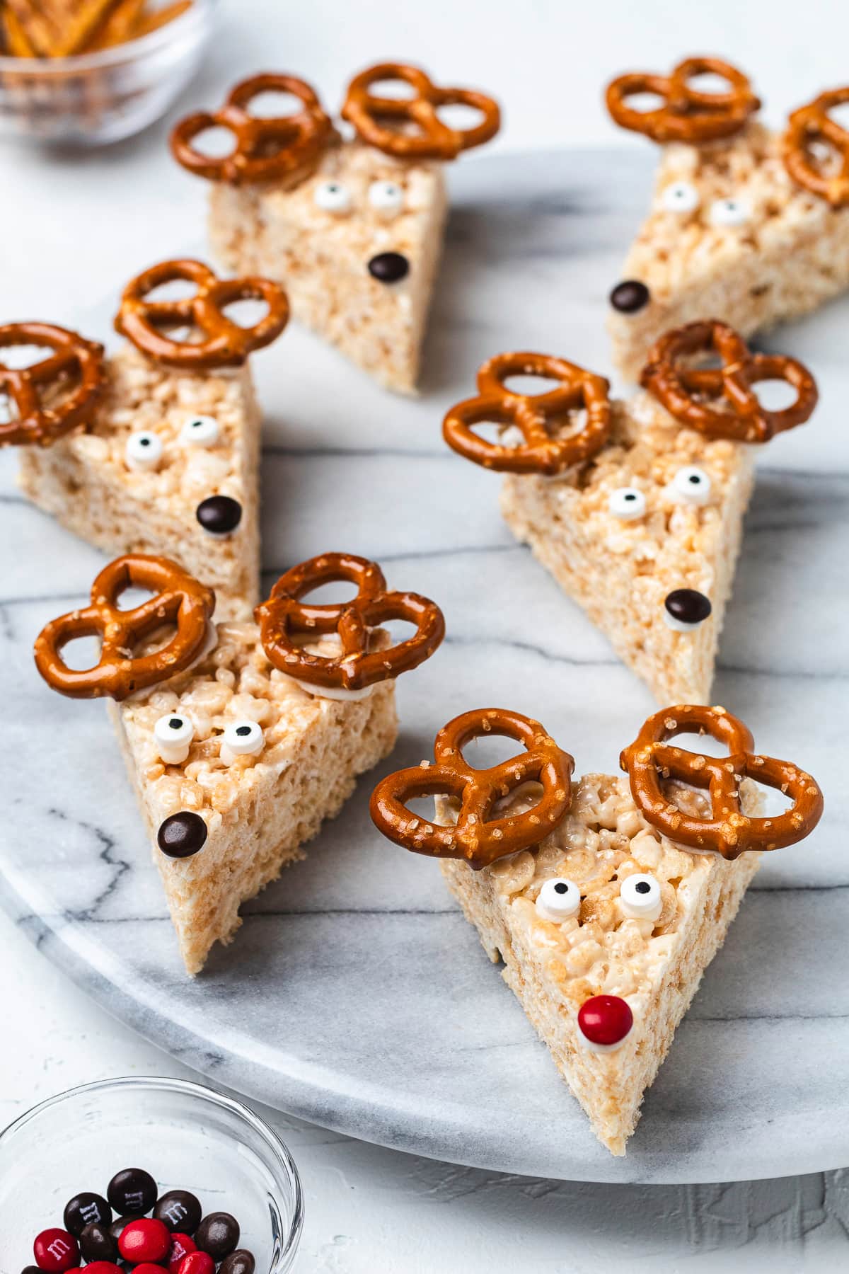 Reindeer Rice Krispie treats decorated with pretzels, candy eyes, and candy noses.
