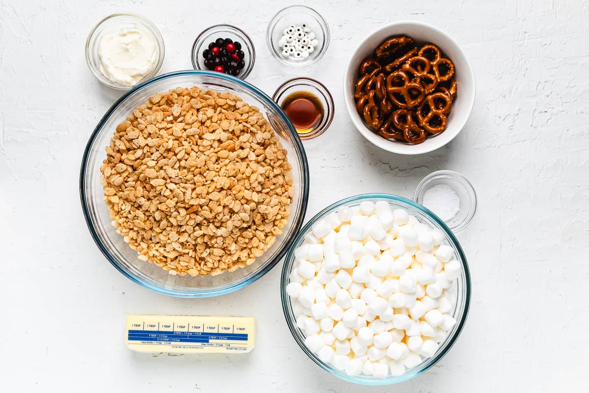 Ingredients for reindeer Rice Krispie treats in glass bowls.