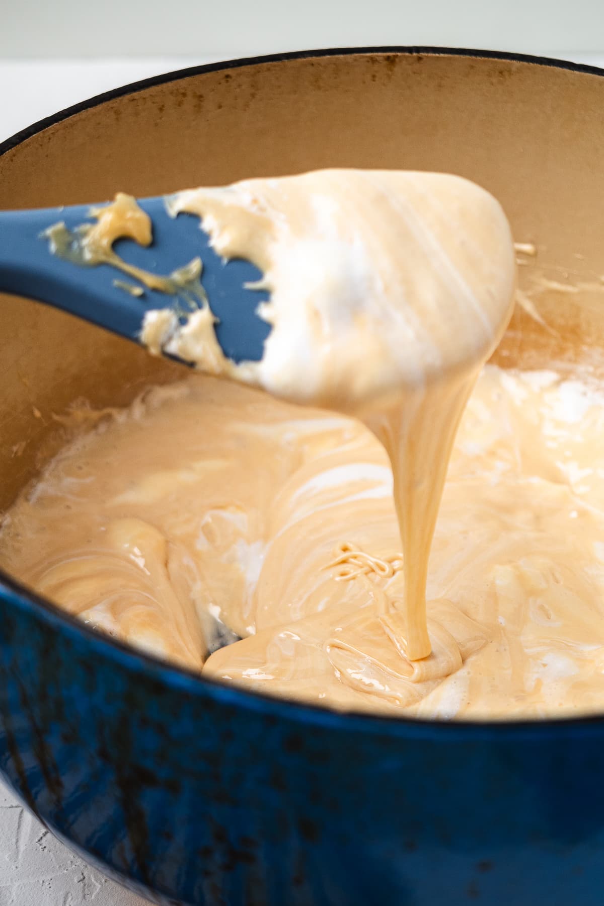 Caramel and marshmallow mixture melting in a Dutch oven.