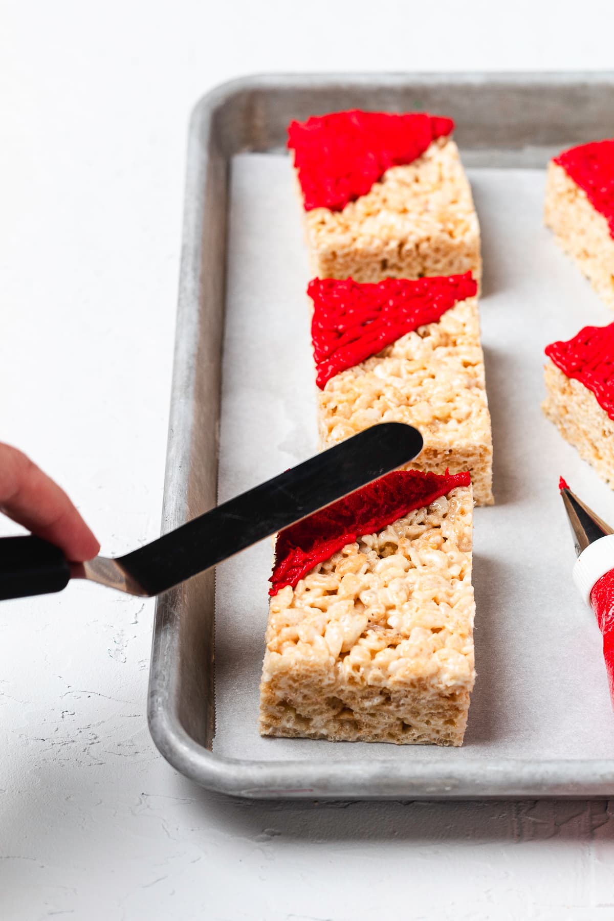 Ingredients for Santa hat Rice Krispie treats in glass bowls.