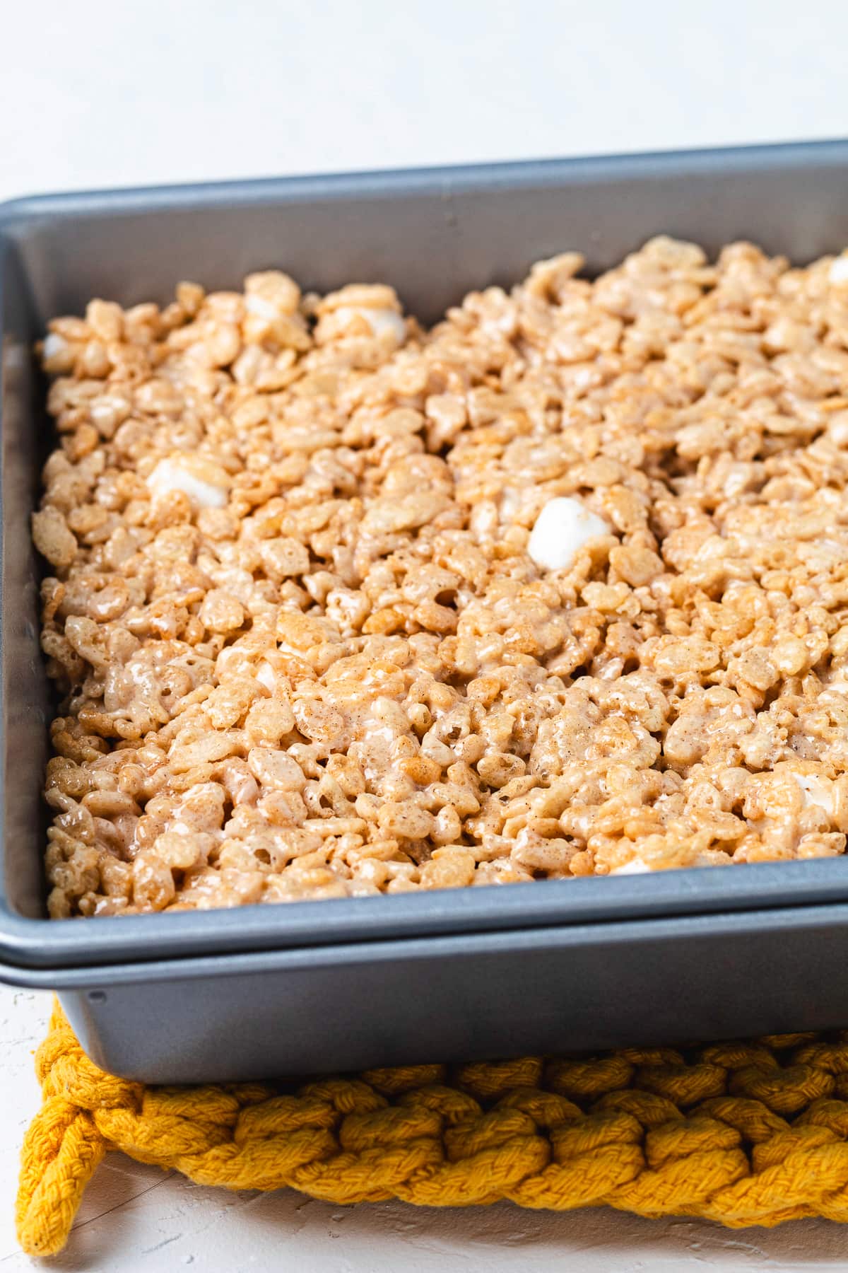 Chai Rice Krispie Treat mixture pressed into a baking pan.