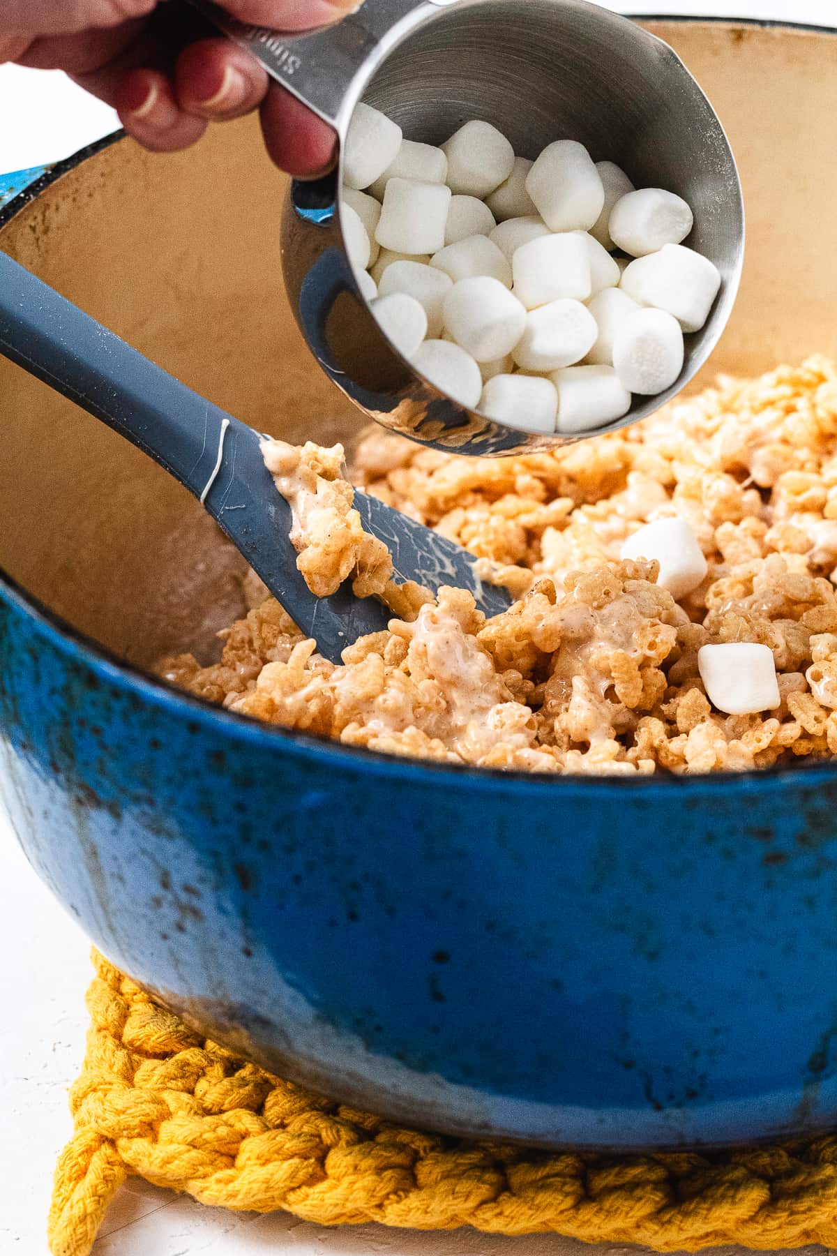 Mini marshmallows added to Rice Krispie mixture.