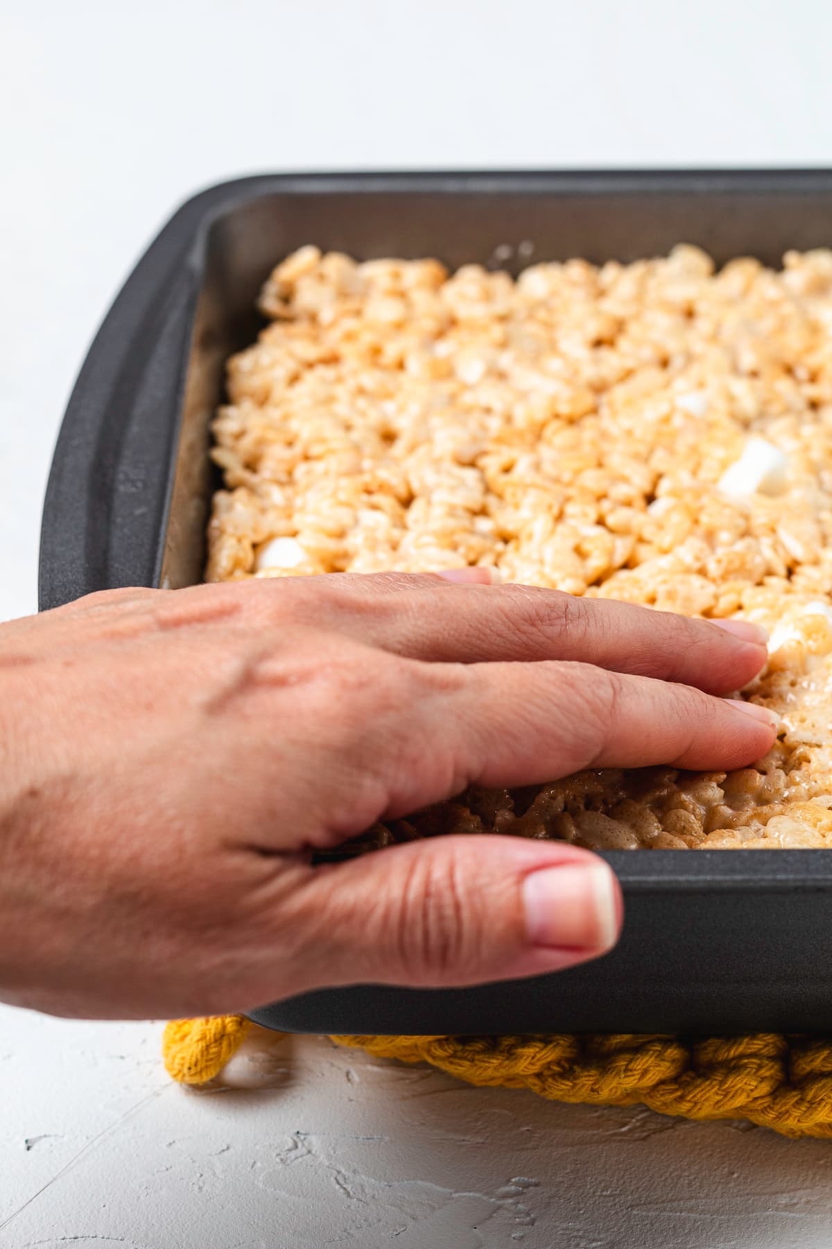 Rice Krispie mixture pressed into a baking pan.