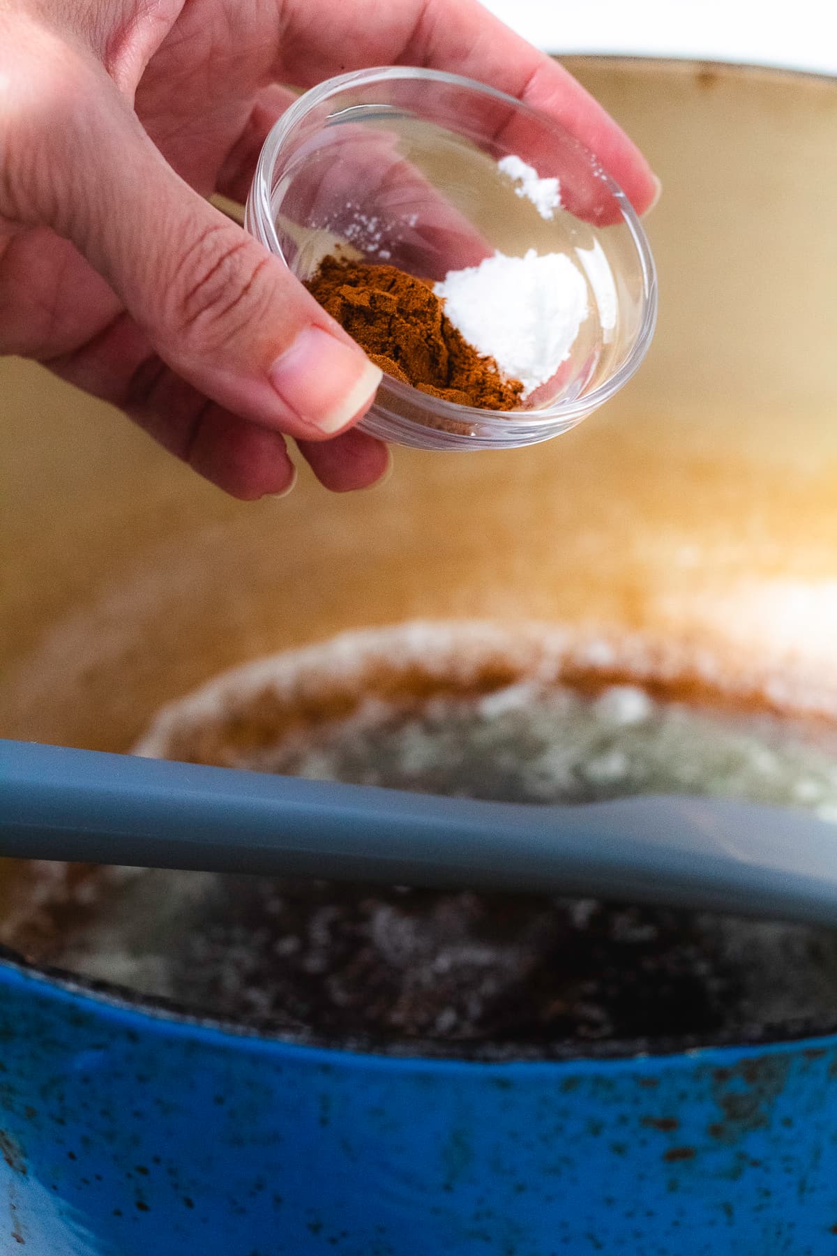 Cinnamon and cream of tartar being added to the marshmallow mixture.