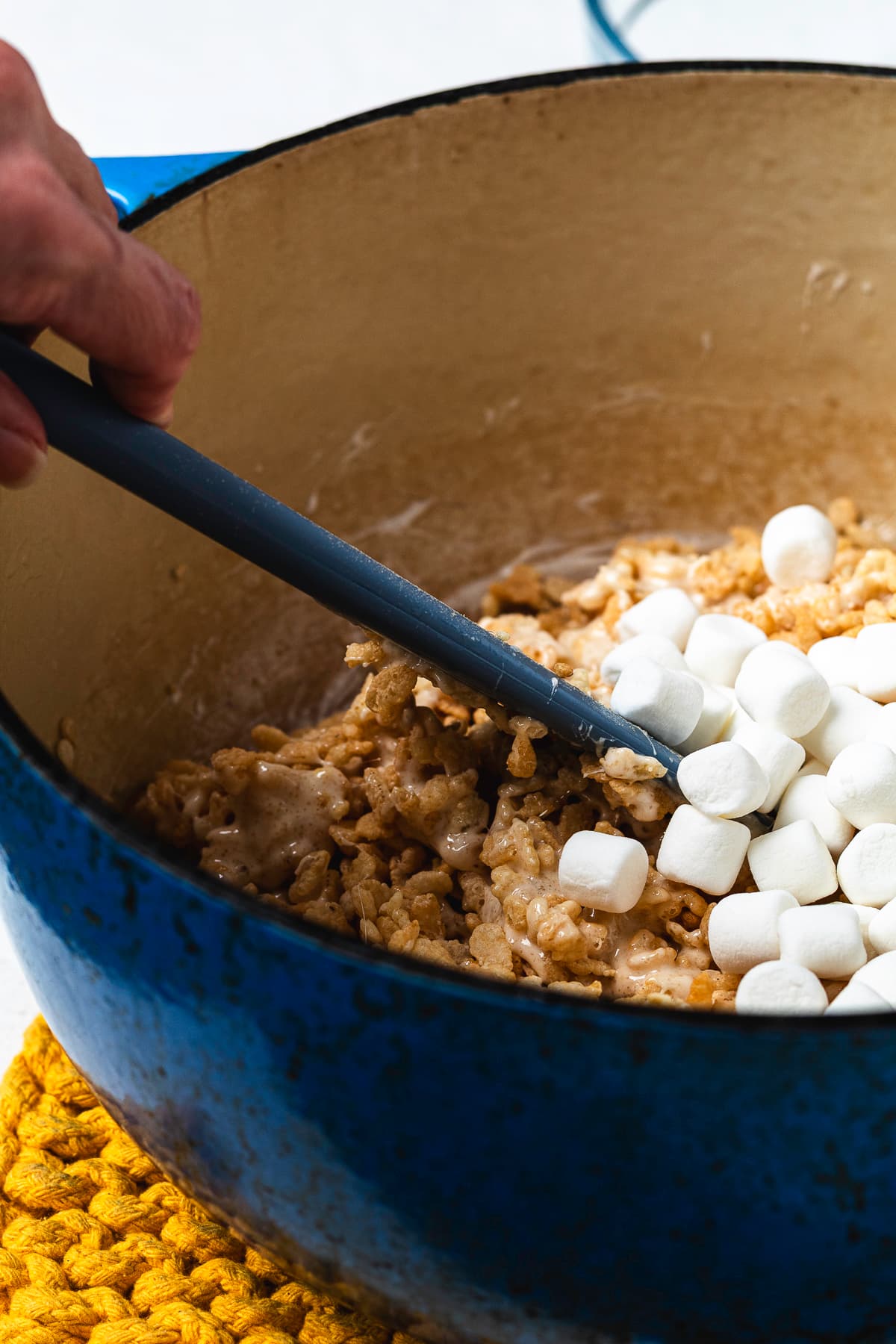 Mini marshmallows being folded into the Rice Krispie mixture.