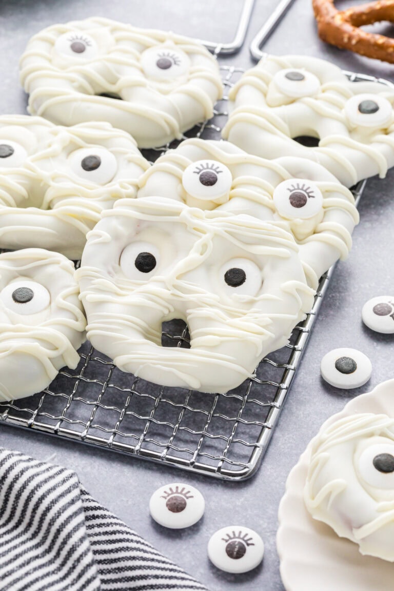 Mummy Halloween pretzels on a cooling rack.