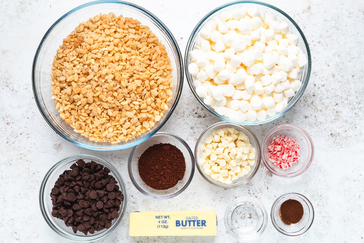 Rice Krispies cereal, marshmallows, chocolate chips, cocoa powder, butter, white chocolate chips, and crushed candy canes.
