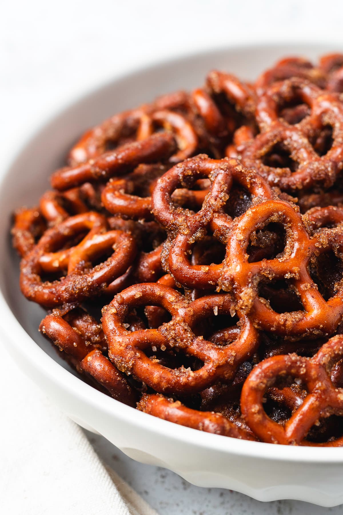 Close-up of crunchy pumpkin spice pretzels coated in a sweet, spiced brown sugar mixture.