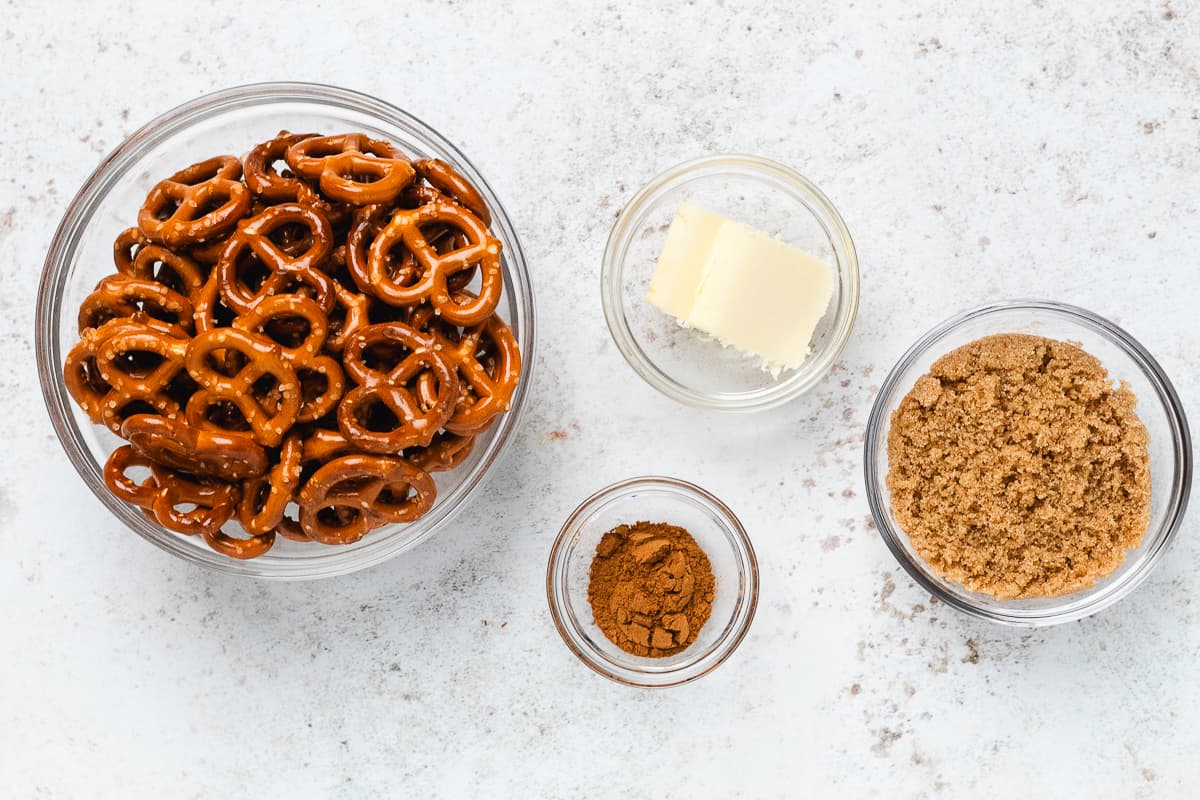 Mini pretzels, butter, brown sugar, and pumpkin pie spice arranged in glass bowls.